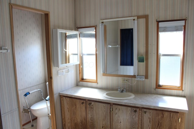 45 Ravine Ridge Dr, Delaware, OH 43015 - bathroom with toilet, vanity, and wallpapered walls