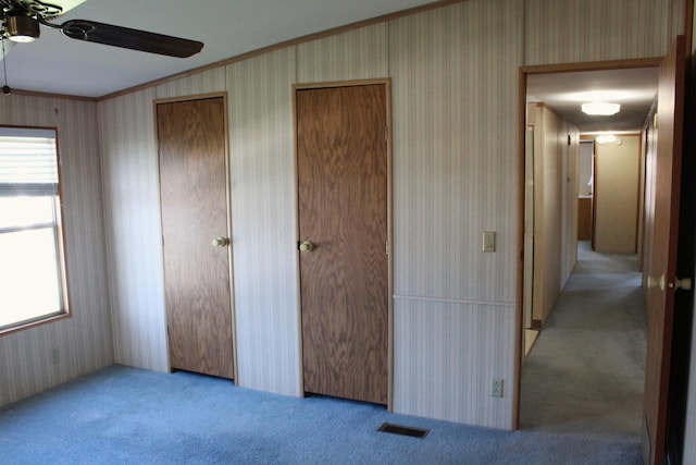 45 Ravine Ridge Dr, Delaware, OH 43015 - unfurnished bedroom featuring a ceiling fan, wallpapered walls, ornamental molding, and carpet floors