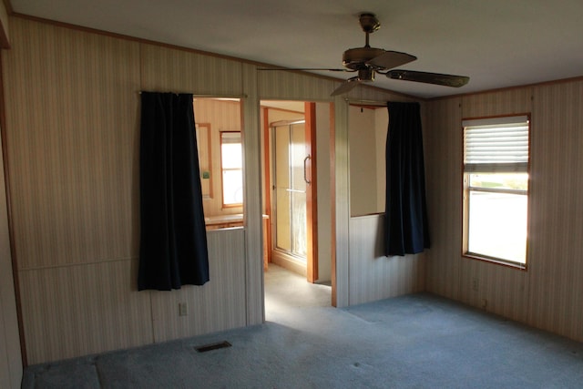 45 Ravine Ridge Dr, Delaware, OH 43015 - unfurnished room featuring visible vents, a ceiling fan, light carpet, and wallpapered walls