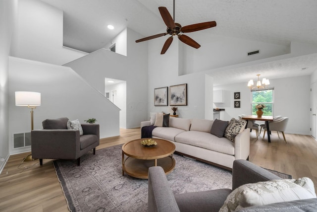 155 Arrowfeather Ln, Lewis Center, OH 43035 - living area with a chandelier, light wood-style flooring, a ceiling fan, baseboards, and high vaulted ceiling