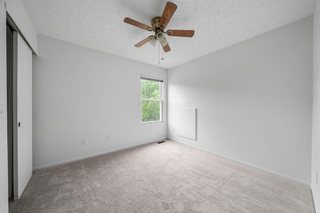 155 Arrowfeather Ln, Lewis Center, OH 43035 - unfurnished bedroom featuring carpet floors, baseboards, a textured ceiling, a closet, and a ceiling fan