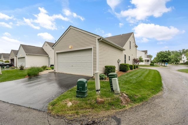 155 Arrowfeather Ln, Lewis Center, OH 43035 - view of side of property with a garage, driveway, a lawn, and a residential view
