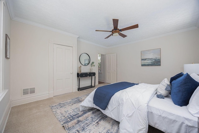 bedroom featuring visible vents, crown molding, a ceiling fan, and light carpet