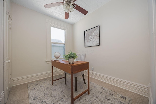 office area with baseboards, light colored carpet, and ceiling fan