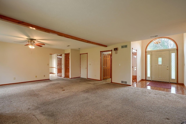 carpeted foyer featuring ceiling fan, baseboards, and visible vents