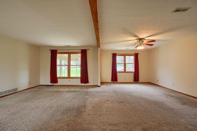 unfurnished room featuring visible vents, ceiling fan, baseboards, and carpet
