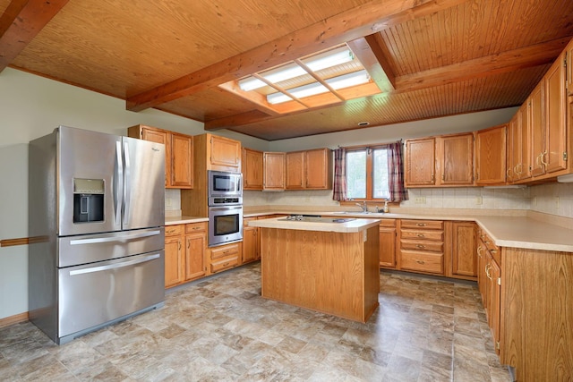 kitchen featuring tasteful backsplash, a sink, light countertops, beam ceiling, and stainless steel appliances