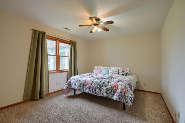 bedroom with ceiling fan, baseboards, visible vents, and carpet floors