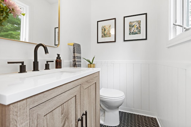 8019 Clouse Rd, New Albany, OH 43054 - half bathroom with vanity, wainscoting, and a decorative wall