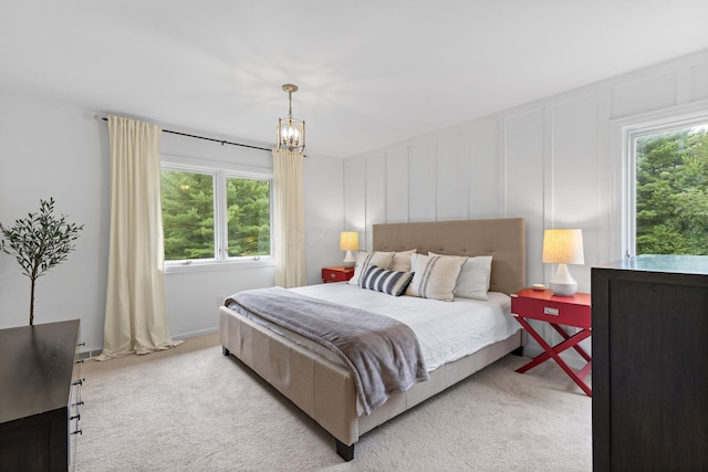 8019 Clouse Rd, New Albany, OH 43054 - carpeted bedroom featuring a decorative wall, multiple windows, and a chandelier