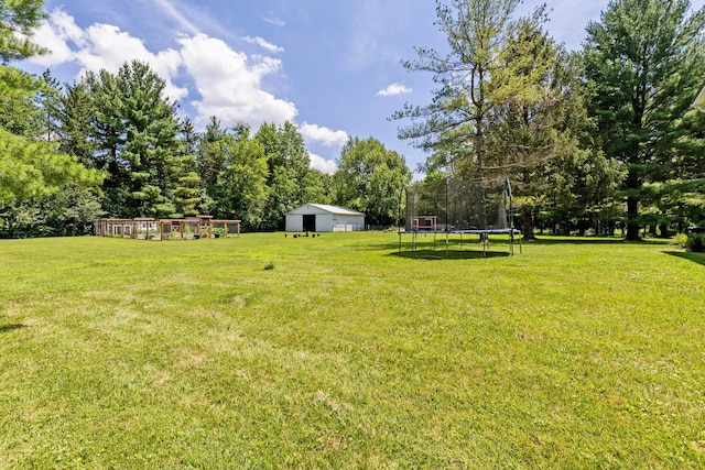8019 Clouse Rd, New Albany, OH 43054 - view of green lawn featuring a trampoline and an outbuilding
