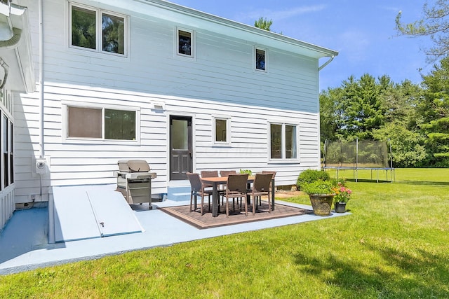 8019 Clouse Rd, New Albany, OH 43054 - back of property with a lawn, a trampoline, and a patio