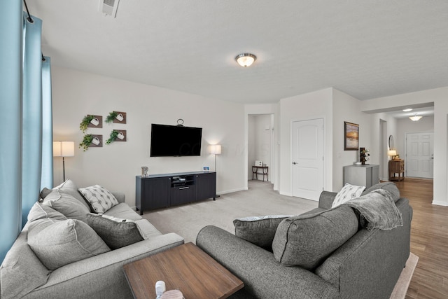 living area featuring baseboards and visible vents