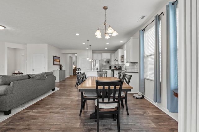 dining room with visible vents, dark wood-style flooring, baseboards, recessed lighting, and a chandelier