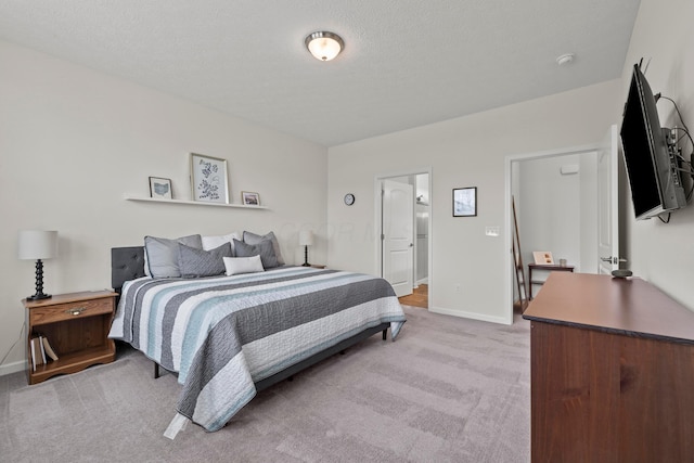 bedroom with baseboards and light carpet