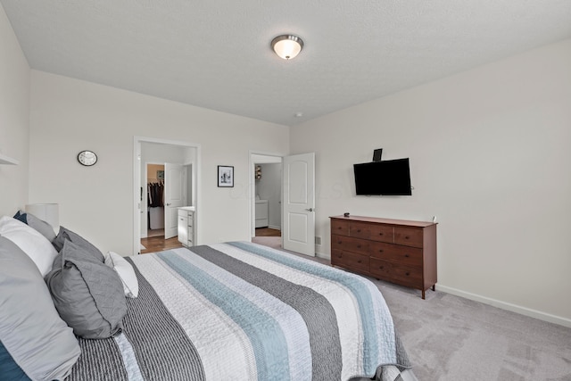 bedroom featuring baseboards, light carpet, and a walk in closet