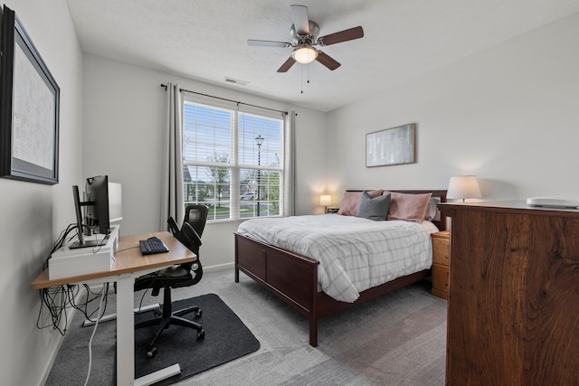 bedroom with baseboards, carpet, a ceiling fan, and visible vents