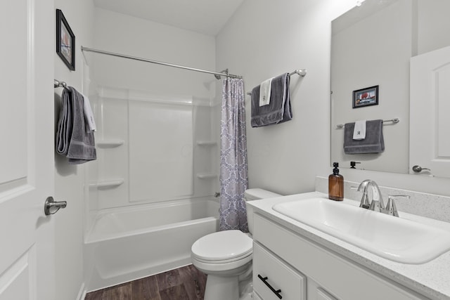 bathroom featuring vanity, toilet, wood finished floors, and shower / tub combo with curtain