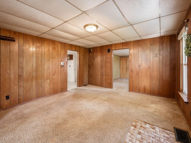88 Tallman St, North Lewisburg, OH 43060 - unfurnished room featuring carpet floors, wooden walls, visible vents, and a drop ceiling