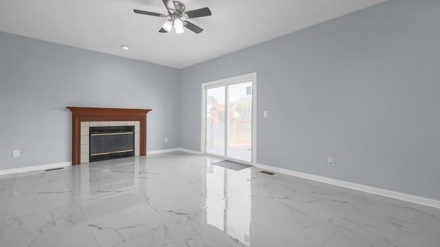 unfurnished living room featuring marble finish floor, baseboards, and ceiling fan