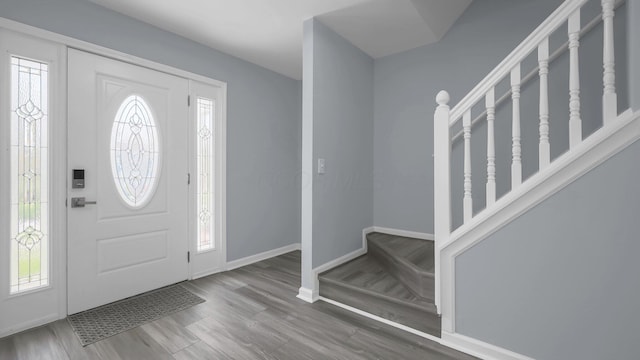 entryway with baseboards, wood finished floors, and plenty of natural light