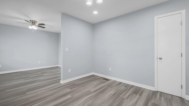 empty room with recessed lighting, wood finished floors, baseboards, and ceiling fan