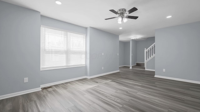 interior space featuring recessed lighting, wood finished floors, baseboards, stairs, and ceiling fan
