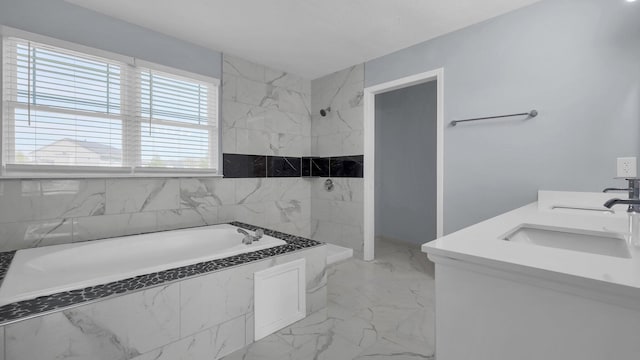 bathroom with marble finish floor, double vanity, a sink, a bath, and a shower
