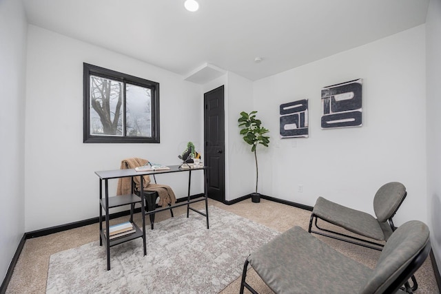 office featuring baseboards and light colored carpet