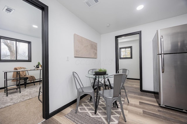 dining area with baseboards, visible vents, and a wealth of natural light