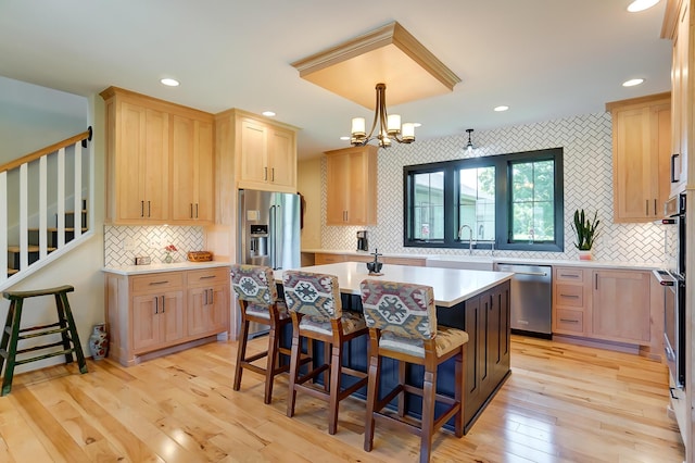 9730 Lancaster Kirkersville Rd NW, Baltimore, OH 43105 - kitchen with light brown cabinetry, light countertops, stainless steel appliances, a center island with sink, and backsplash