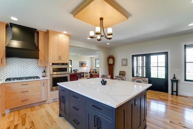9730 Lancaster Kirkersville Rd NW, Baltimore, OH 43105 - kitchen featuring light wood-type flooring, custom exhaust hood, appliances with stainless steel finishes, a healthy amount of sunlight, and light brown cabinets