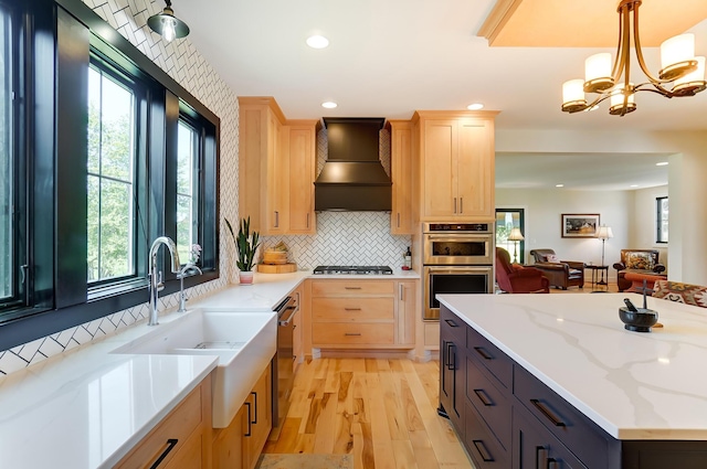 9730 Lancaster Kirkersville Rd NW, Baltimore, OH 43105 - kitchen with light brown cabinets, a sink, appliances with stainless steel finishes, premium range hood, and light wood-style floors