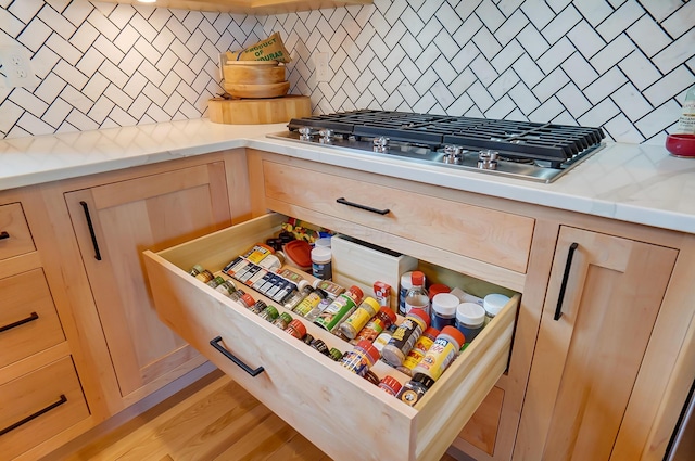 9730 Lancaster Kirkersville Rd NW, Baltimore, OH 43105 - room details featuring light countertops, decorative backsplash, light brown cabinets, and stainless steel gas stovetop