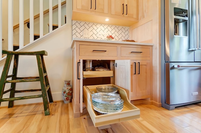 9730 Lancaster Kirkersville Rd NW, Baltimore, OH 43105 - details with light wood-style flooring, light brown cabinetry, tasteful backsplash, stainless steel refrigerator with ice dispenser, and light countertops