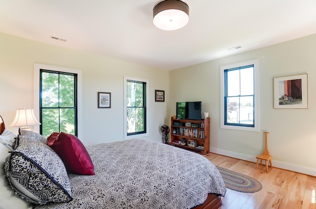 9730 Lancaster Kirkersville Rd NW, Baltimore, OH 43105 - bedroom featuring light wood finished floors, baseboards, multiple windows, and visible vents