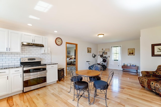 9730 Lancaster Kirkersville Rd NW, Baltimore, OH 43105 - kitchen featuring white cabinets, light wood-type flooring, under cabinet range hood, and double oven range