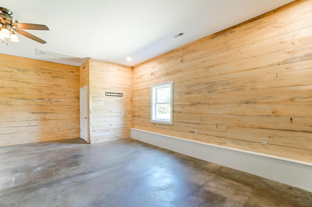 9730 Lancaster Kirkersville Rd NW, Baltimore, OH 43105 - unfurnished room with visible vents, ceiling fan, wood walls, and concrete flooring