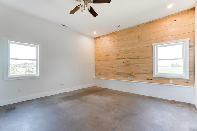 9730 Lancaster Kirkersville Rd NW, Baltimore, OH 43105 - spare room with a healthy amount of sunlight, wooden walls, visible vents, and concrete flooring