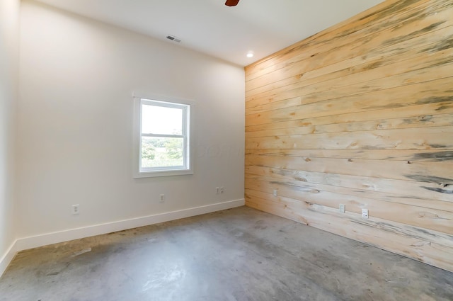 9730 Lancaster Kirkersville Rd NW, Baltimore, OH 43105 - spare room featuring visible vents, baseboards, wood walls, and concrete floors