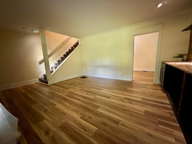 9962 Weaver Rd, Utica, OH 43080 - unfurnished living room featuring stairs, crown molding, wood finished floors, baseboards, and recessed lighting