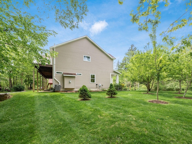 9684 Shawnee Trl, Powell, OH 43065 - rear view of house with a lawn and central AC