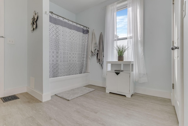 328 Pearl St, Jackson, OH 45640 - full bath with wood finished floors, visible vents, baseboards, and shower / tub combo