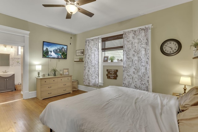 328 Pearl St, Jackson, OH 45640 - bedroom with light wood-style floors, a ceiling fan, baseboards, and a sink