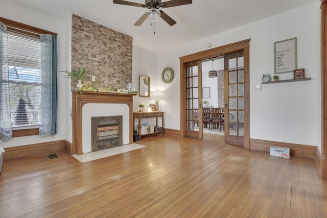 328 Pearl St, Jackson, OH 45640 - unfurnished living room featuring visible vents, baseboards, wood finished floors, ceiling fan, and a fireplace
