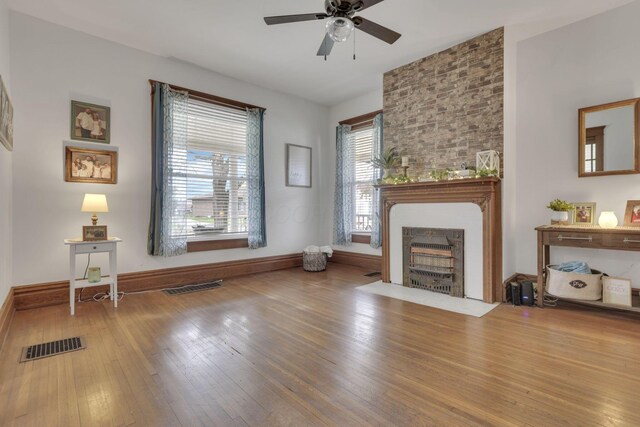 328 Pearl St, Jackson, OH 45640 - living area featuring ceiling fan, wood-type flooring, visible vents, and a fireplace