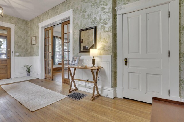 328 Pearl St, Jackson, OH 45640 - entryway with wallpapered walls, light wood finished floors, and wainscoting