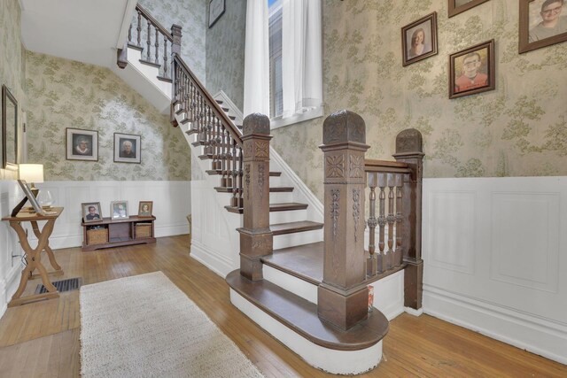 328 Pearl St, Jackson, OH 45640 - stairs featuring wainscoting, a decorative wall, hardwood / wood-style floors, and wallpapered walls