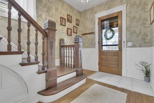 328 Pearl St, Jackson, OH 45640 - entryway with wallpapered walls, wood finished floors, stairs, and wainscoting