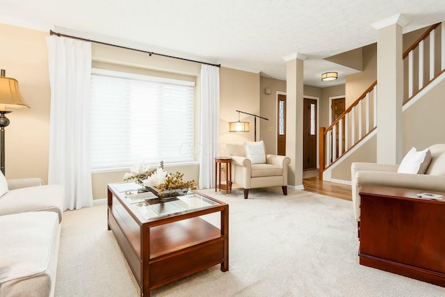 carpeted living area with stairway and baseboards